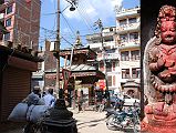 Kathmandu 04 01 Buddha, Hindu Temple, and Statue Near Kathesimbhu Stupa Just before reaching the Kathesimbhu Stupa, I think in Thahiti Tole, I admired Buddha watching over a Hindu Temple, and a small statue to the right of the temple. The statue looks like Mahakala, holding a chopper in his right hand, a skull cup in the left, and a mace under his left arm.